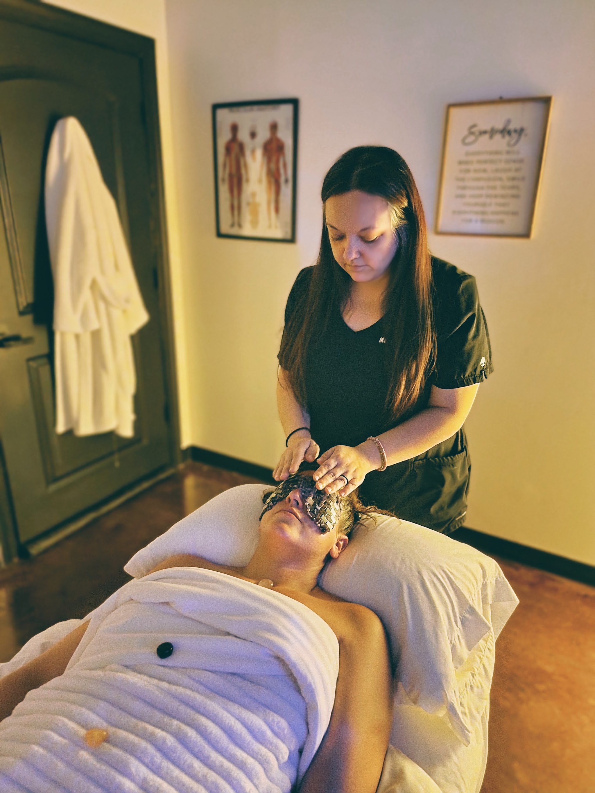 One of our therapists giving a facial in a softly lit treatment room